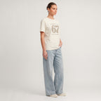 Kiksy cream funny mum t-shirt featuring the slogan Please don't say 67 a mum's worst nightmare, modelled by a woman.