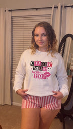 Kiksy white sweatshirt featuring a pink and black Chaotic Mum but like HOT graphic print worn by a smiling woman