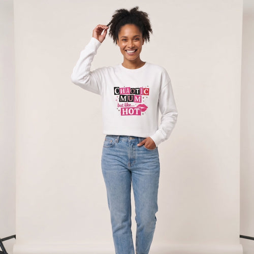 Kiksy white sweatshirt featuring a pink and black Chaotic Mum but like HOT graphic print worn by a smiling woman