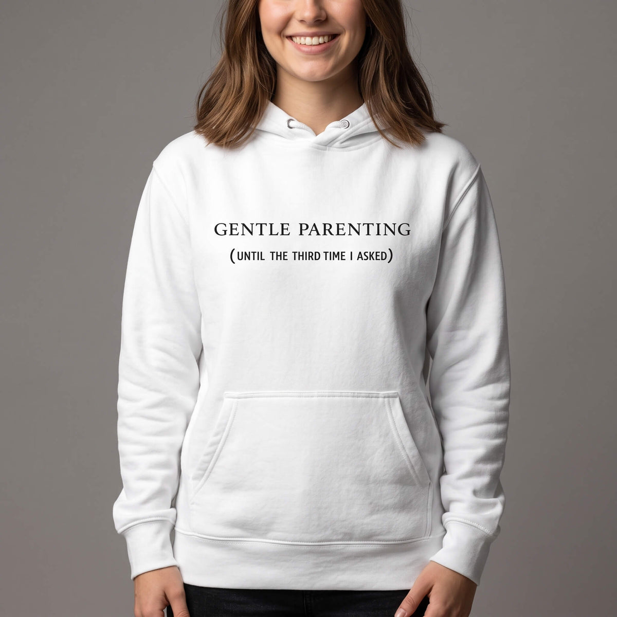 Kiksy white organic cotton hoodie for women featuring gentle parenting slogan printed on front.