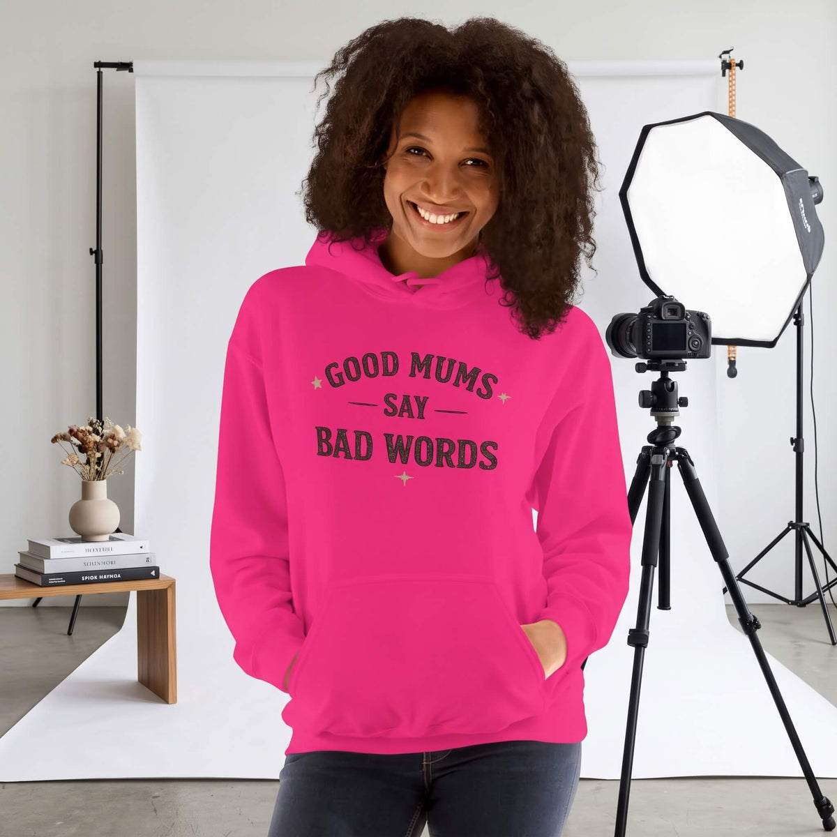 Kiksy pink hoodie with Good Mums Say Bad Words printed on the front worn by a smiling woman