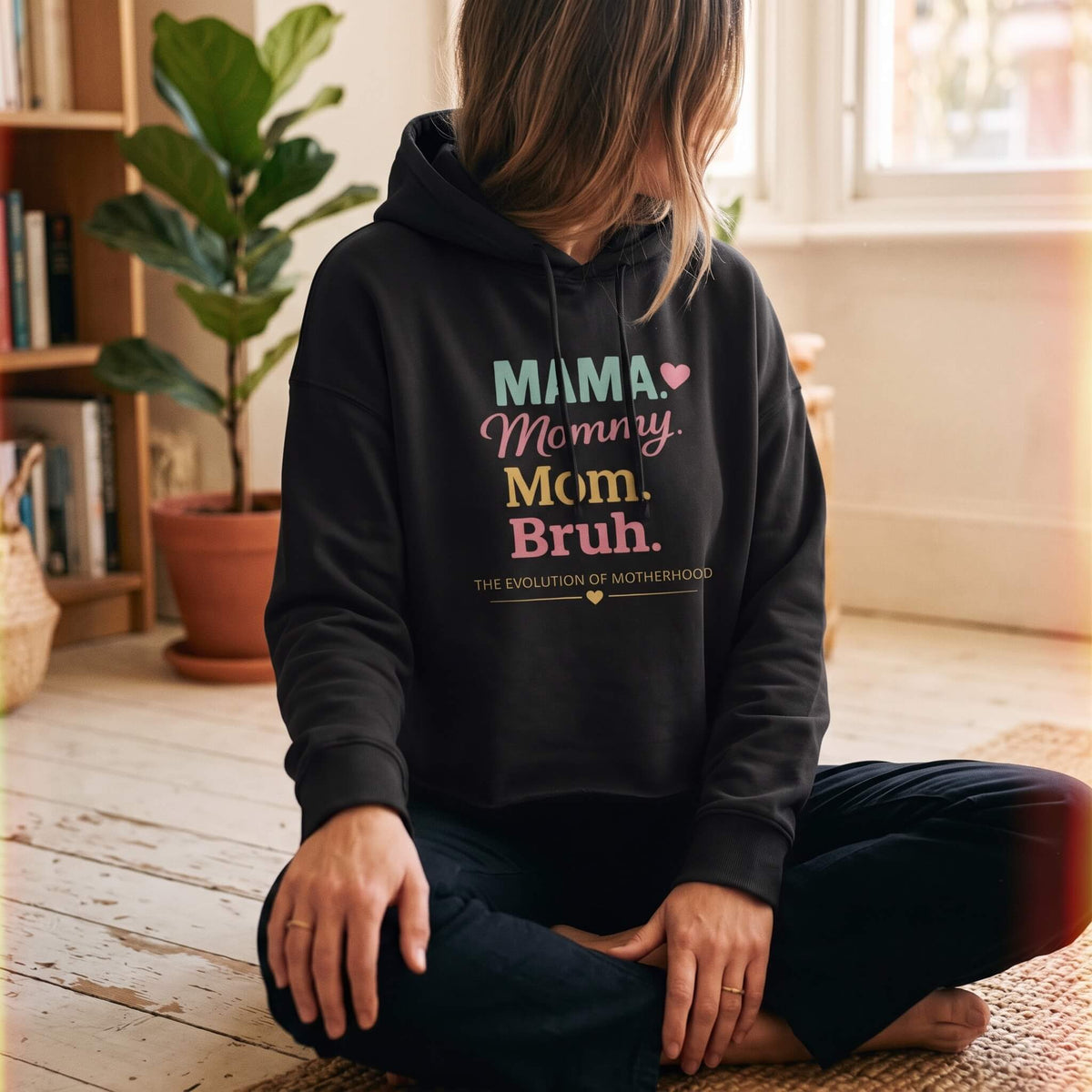 Kiksy black mom hoodie featuring the print Evolution of Motherhood Mama Mommy Mom Bruh on soft fleece fabric.