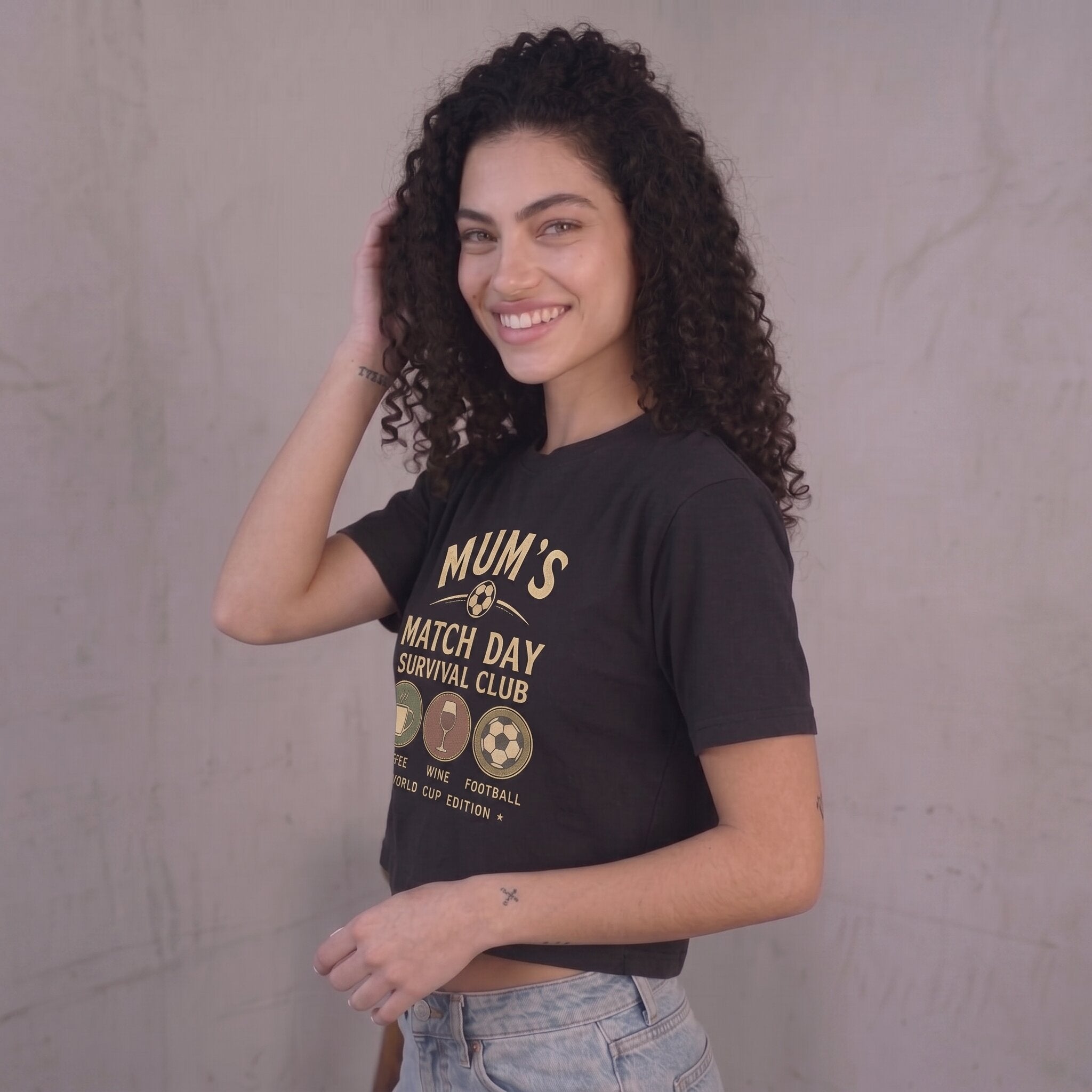 Kiksy black cropped t-shirt for women featuring a graphic print that reads Mum's Match Day Survival Club.