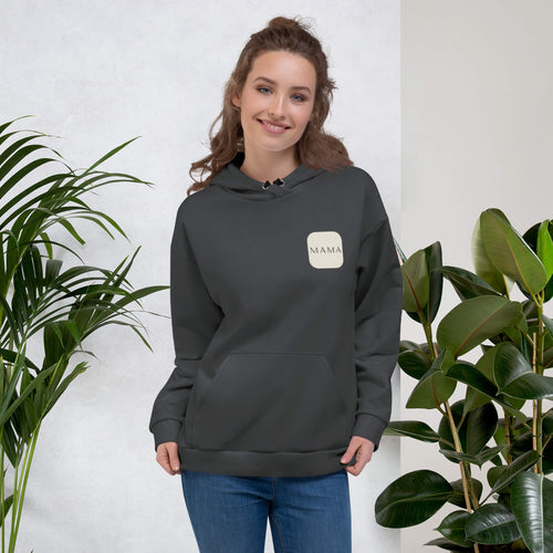 Woman smiling in a Kiksy charcoal grey hoodie featuring a cream square MAMA chest logo.