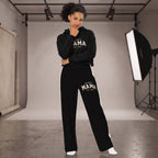 Kiksy black wide leg mama joggers with white side stripes and collegiate print, worn by a smiling model in a studio.
